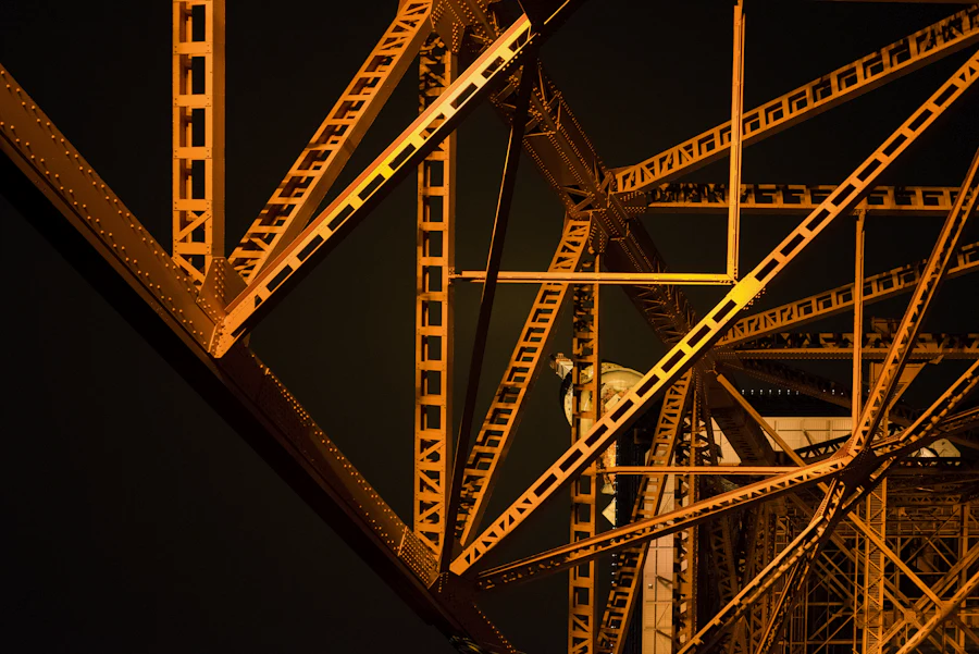 Orange-lit steel trusses at night
