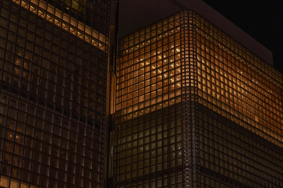 Bronze-lit grid facade of an office building at night